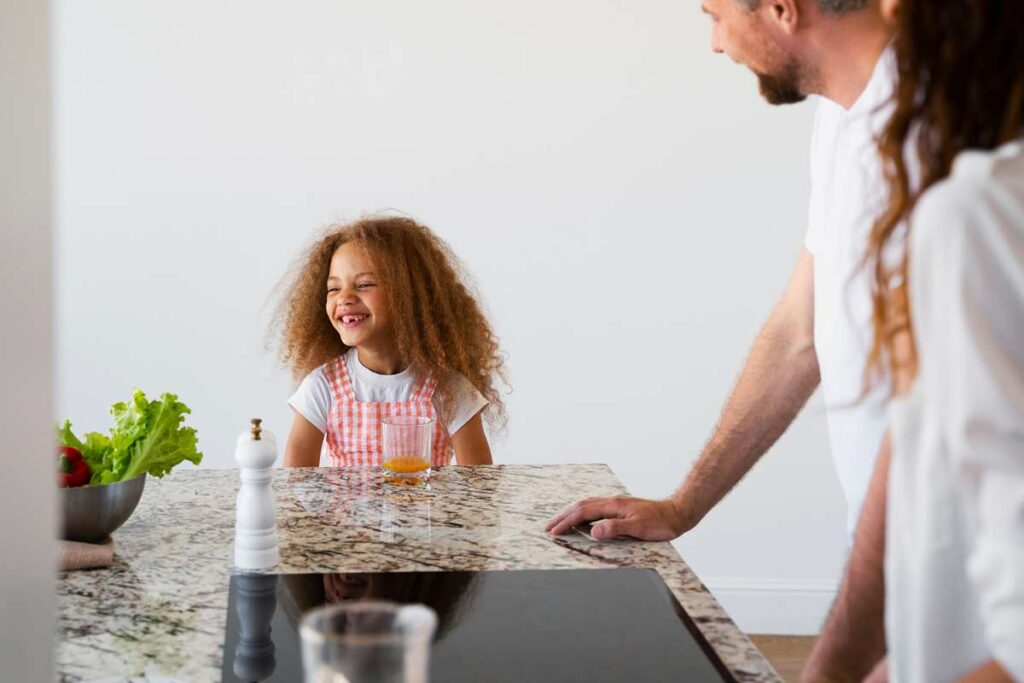 A close-up view of a quartz countertop with an eased edge, showing its smooth, slightly rounded corner that offers a modern and safe kitchen finish.