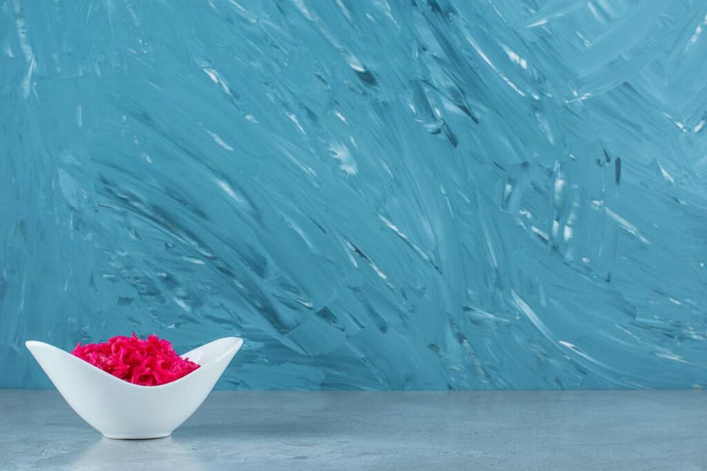 A stylish kitchen featuring blue quartz countertops with a glossy finish, highlighting their durability, elegance, and unique color variation.