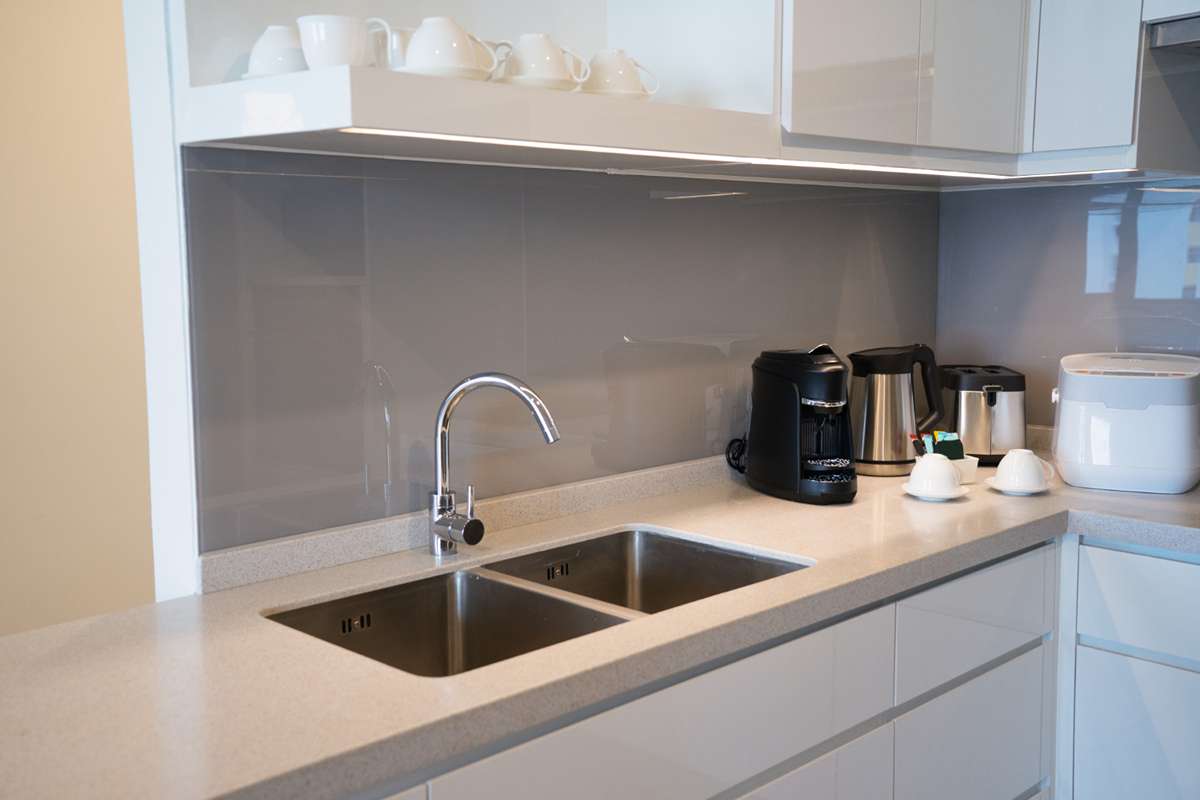 Custom-designed cement kitchen sink installed in a modern kitchen with wooden cabinets