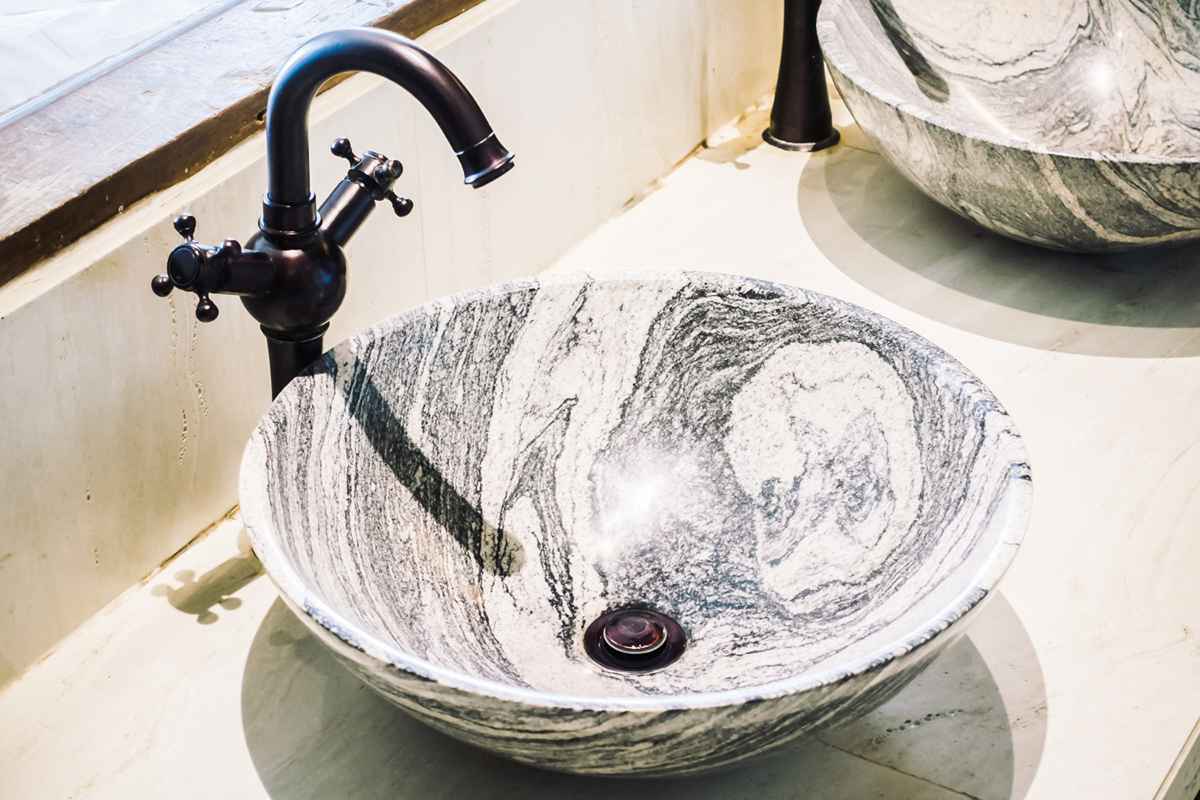 White pedestal marble sink with elegant design in bathroom