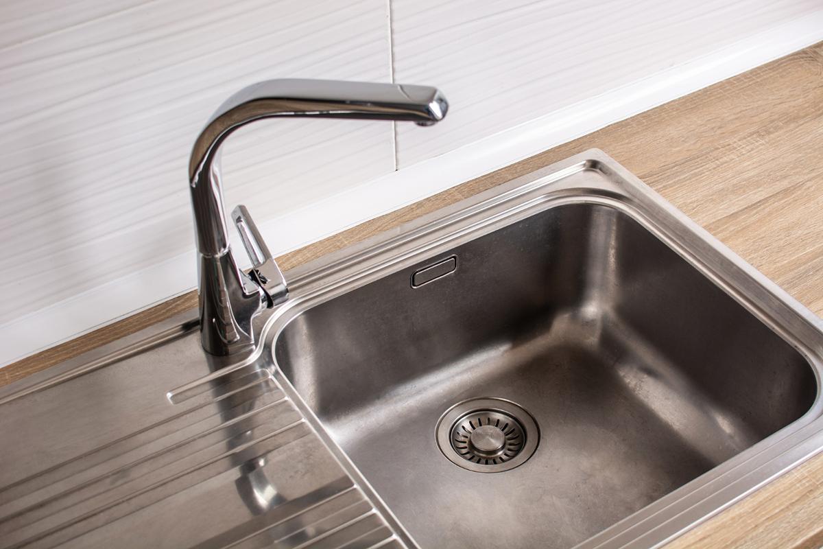 Service sink in a janitor closet used for cleaning mops and tools