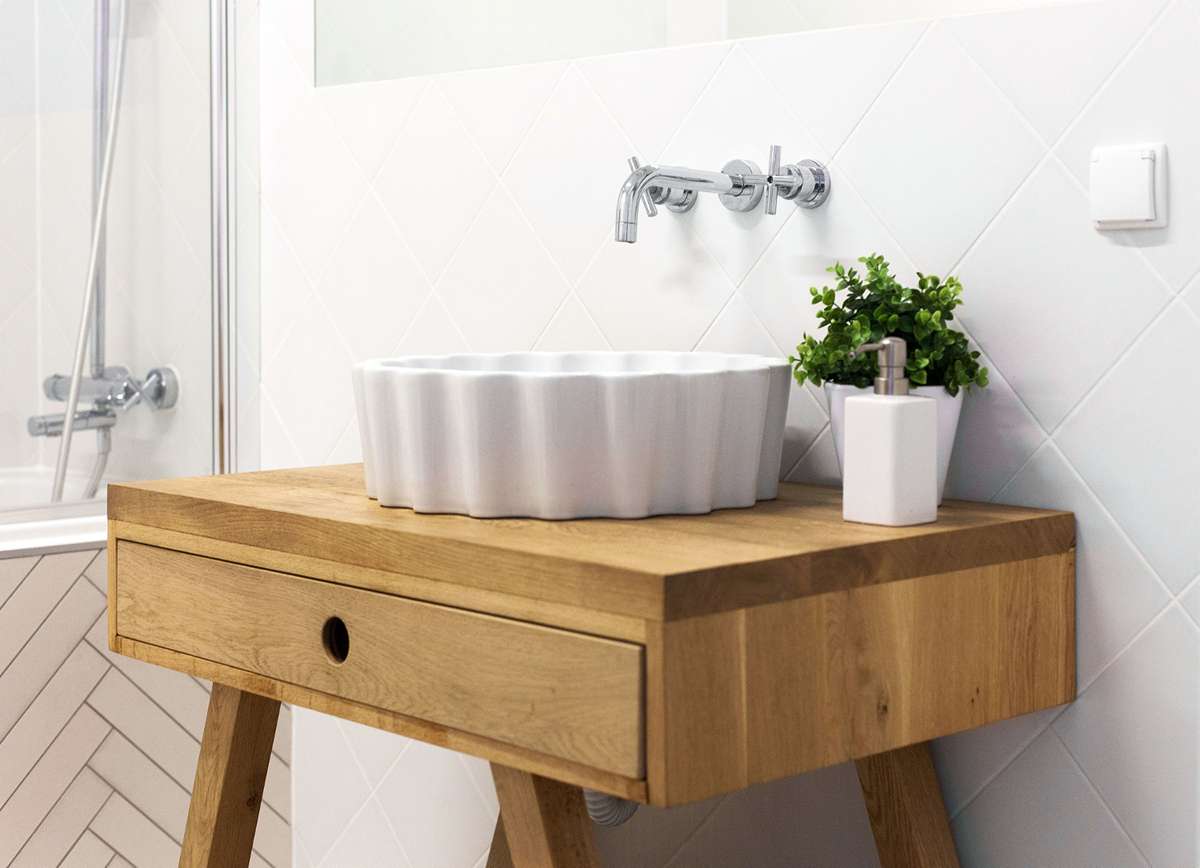 Rustic sink vanity made of reclaimed wood in farmhouse bathroom