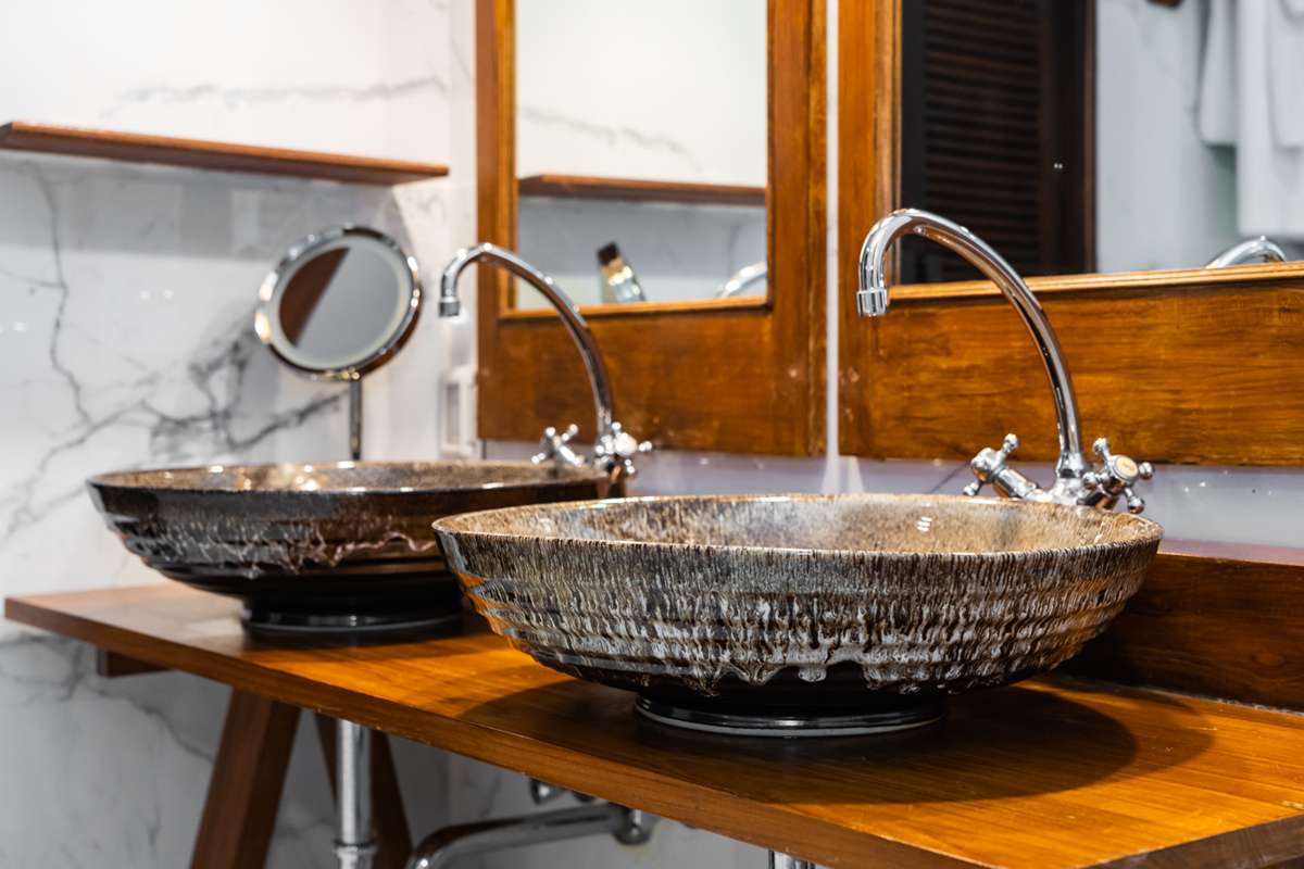 White trough sink with 2 faucets in modern bathroom